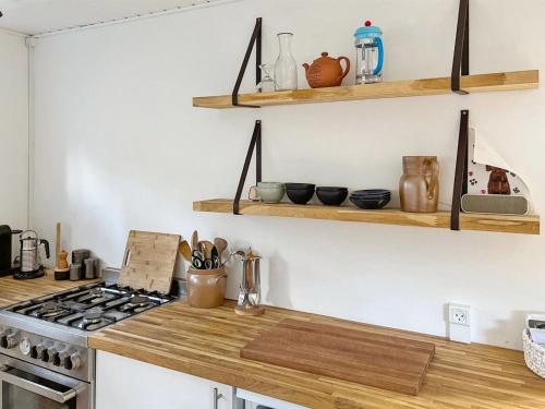 a kitchen with wooden counter tops and wooden shelves at Holiday Home Othinkarl - 150m from the sea by Interhome in Neksø