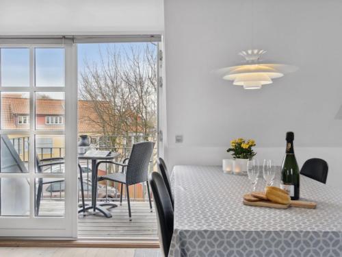 a dining room with a table and a balcony at Apartment Ayna - 150m from the sea by Interhome in Skagen