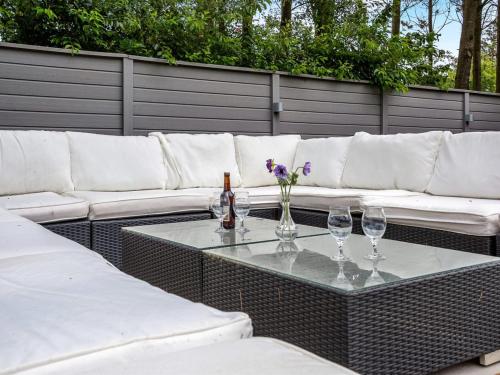a table with glasses and a bottle of wine on at Holiday Home Annelisa - 200m to the fjord by Interhome in Ulfborg