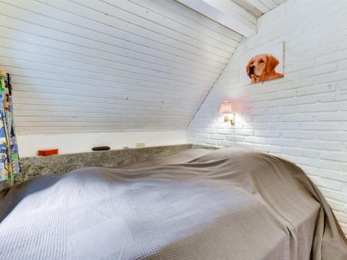 a bed in a room with a dog on the wall at Holiday Home Annelisa - 200m to the fjord by Interhome in Ulfborg