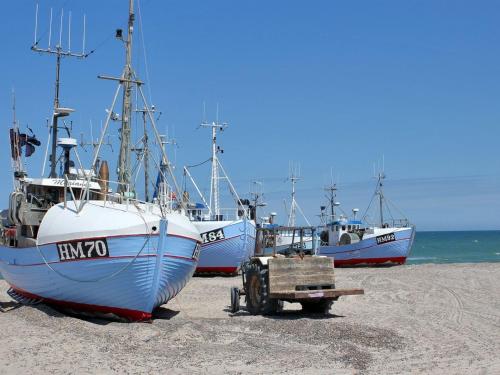 three boats sitting on the beach with a trailer at Holiday Home Annick - 300m from the sea by Interhome in Fjerritslev