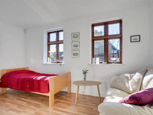 a white living room with a couch and a table at Holiday Home Iarund - 500m to the inlet by Interhome in Løgstør