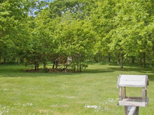 a white bench in a field with trees at Holiday Home Hailka by Interhome in Give