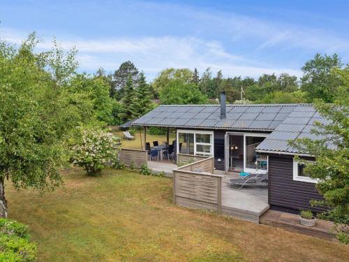 a house with a solar roof on a yard at Holiday Home Holmwith - 200m from the sea by Interhome in Vesterby