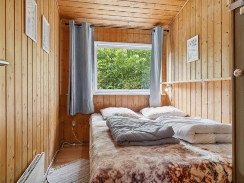 a room with three beds in it with a window at Holiday Home Zoya - 470m from the sea by Interhome in Gedser