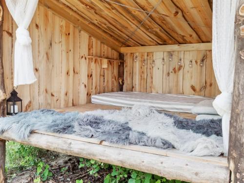 a wooden cabin with two beds in it at Holiday Home Thorlak - 860m from the sea by Interhome in Marielyst