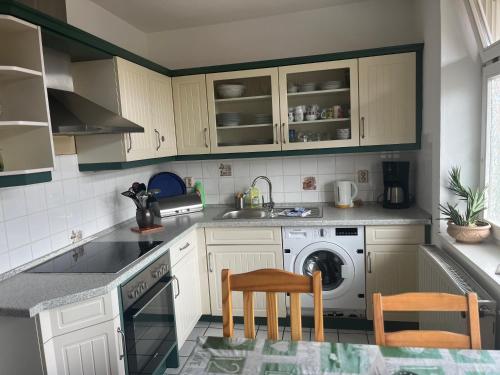 a kitchen with a sink and a washing machine at Ferienwohnung Kaufmannshof in Quedlinburg