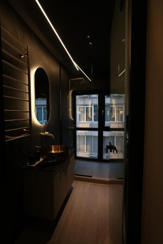 a bathroom with a sink and a large window at MeTHEA in Thessaloniki
