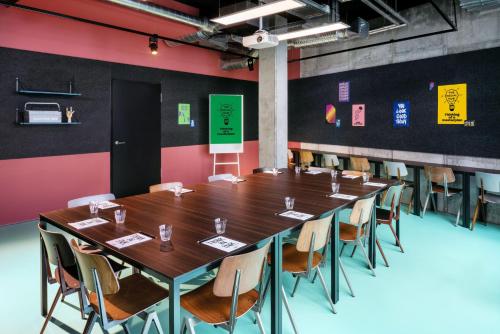 a large conference room with a long table and chairs at The Social Hub Berlin Alexanderplatz in Berlin