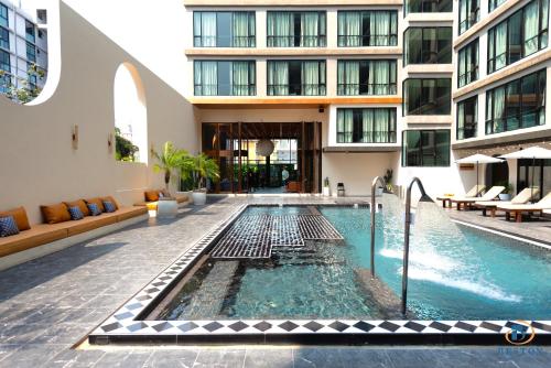 a swimming pool in the middle of a building at Beston Pattaya - SHA Plus Certified in Pattaya South