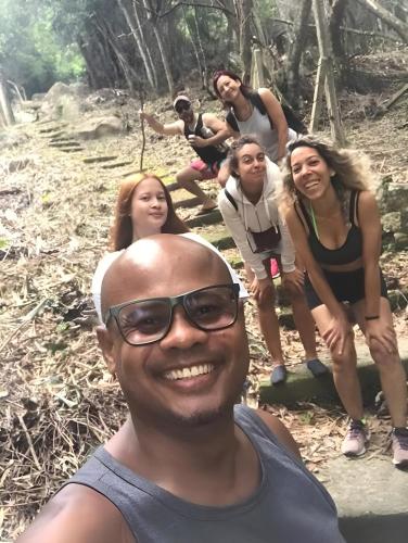 a man standing in front of a group of people on a trail at Nômades Beach - Adventure Hostels in Florianópolis