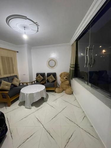 a teddy bear sitting on the floor in a living room at Dar Chefchauen in Chefchaouene