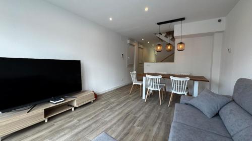 a living room with a couch and a table with chairs at Casa Florida Hernani in Hernani