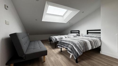 a row of beds in a room with a skylight at Casa Florida Hernani in Hernani