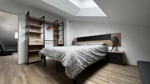 a bedroom with a bed and a book shelf at Casa Florida Hernani in Hernani
