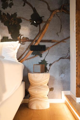 a bedroom with a bed and a wall with a painting at Boutiquehotel Kloster Pfalzel in Trier
