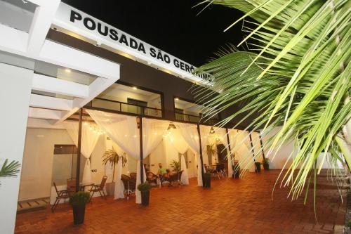a lobby of a building with tables and chairs at Pousada São Gerônimo in Matinhos