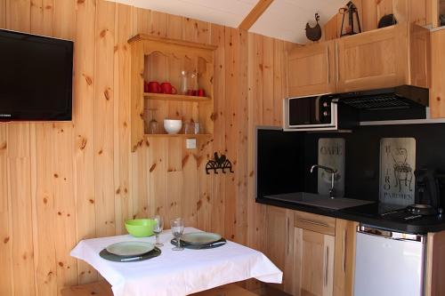 a kitchen with a table with two plates on it at Shangri La in Saint-Jean-Saint-Nicolas