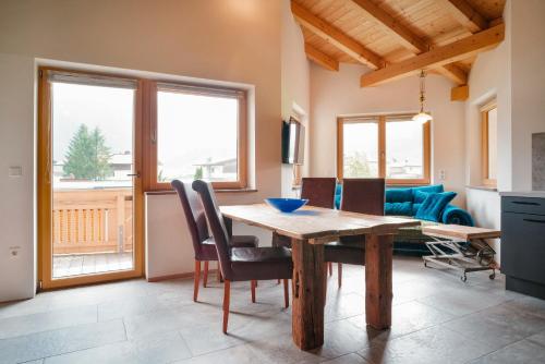 a dining room with a wooden table and chairs at Appartement Resi in Achensee