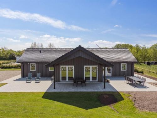 a house with a deck and a patio at Holiday Home Ika - 450m from the sea by Interhome in Nordborg