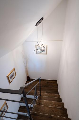 a staircase in a house with a chandelier at Cosy home D&D in Brod Moravice