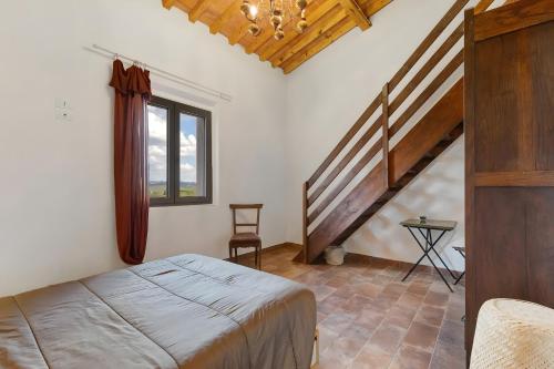a bedroom with a bed and a stair case at Fattoria le Caprine in Querce