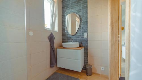 a bathroom with a sink and a mirror at Vila Familia in Turčianske Teplice