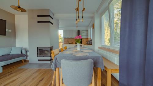a dining room with a table and chairs and a living room at Vila Familia in Turčianske Teplice