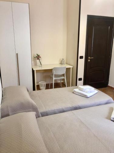 a bedroom with a bed and a desk with a table at BeB Lucky House Francesca in Scafati