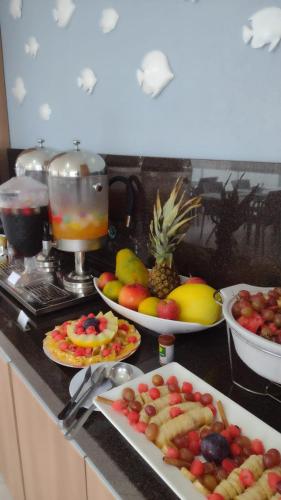 a kitchen counter with plates of fruit on it at Pousada São Gerônimo in Matinhos