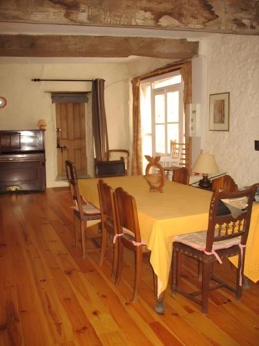 a dining room with a yellow table and chairs at Chez Janie Hirst - Chambres d'hôtes in Montboucher-sur-Jabron