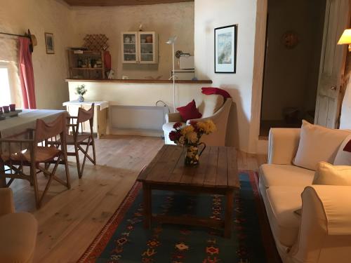 a living room with a couch and a table at Chez Janie Hirst - Chambres d'hôtes in Montboucher-sur-Jabron