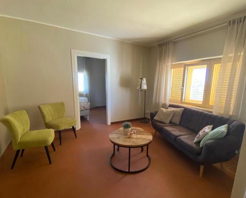 a living room with a couch and a table and chairs at Casa Amrita B&B in Teramo