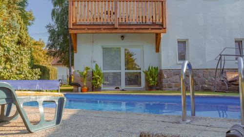 a house with a deck over a swimming pool at Vila Familia in Turčianske Teplice