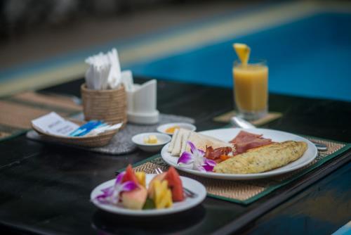 a table with plates of food on top at Reasey Boutique Villa in Siem Reap