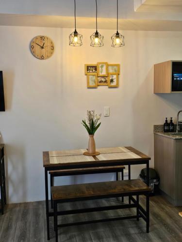 a dining room with a table and a clock on the wall at Bayay ni Lola in Mactan Cebu International