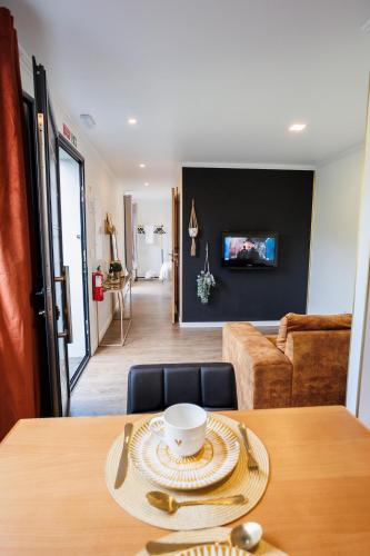 a dining room with a table and a living room at Green Shelter - Guest House in Santana