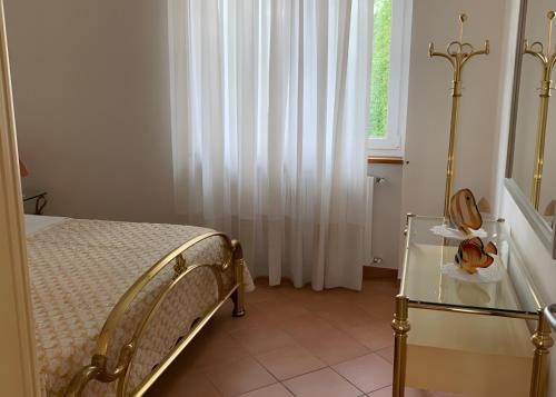 a bedroom with a bed and a glass table at Casa Vacanza al Capriano in Cantello