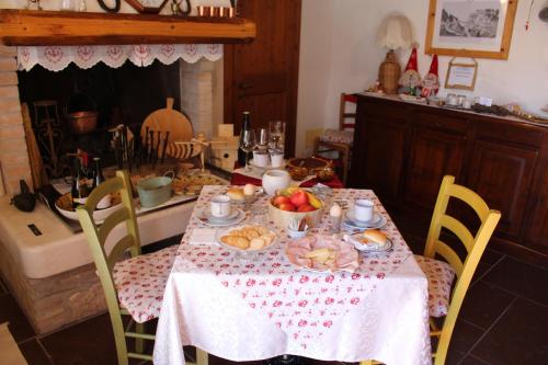 a dining room table with a table cloth with food on it at Giuliva B&B in Refrontolo