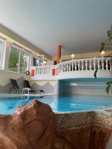 a large swimming pool with a rock in the middle at Hotel Alpina nature-wellness in Wenns