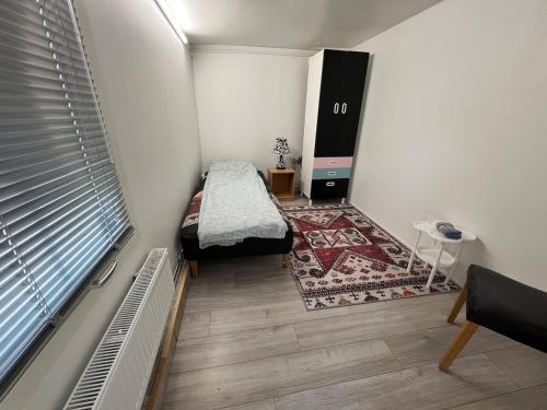 a small room with a bed and a rug at 2 bedrooms and kitchen-mini Villa in Västerås