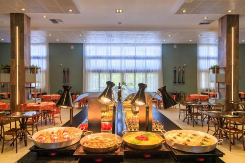 a buffet of food on a table in a restaurant at Vivá Porto de Galinhas Resort in Porto De Galinhas
