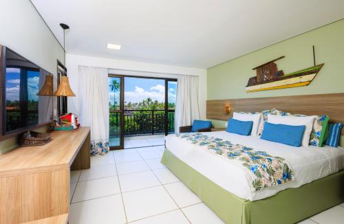 a bedroom with a large bed and a balcony at Vivá Porto de Galinhas Resort in Porto De Galinhas