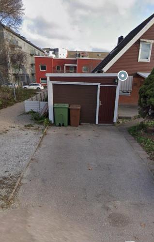 a garage in a driveway next to a house at 2 bedrooms and kitchen-mini Villa in Västerås