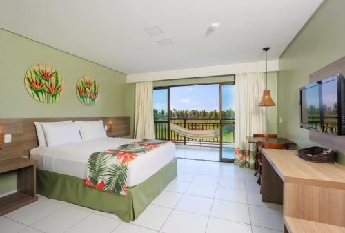 a hotel room with a bed and a balcony at Vivá Porto de Galinhas Resort in Porto De Galinhas