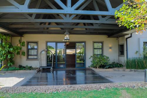 a front door of a house with a wooden ceiling at Greenwood Manor Hotel in Ndola