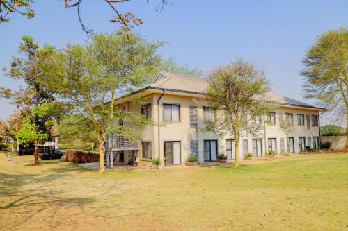 an image of a house with a yard at Greenwood Manor Hotel in Ndola