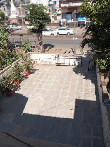a sidewalk with a bench on a city street at Swanky Homestay in Kolhapur