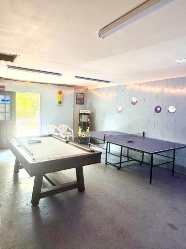 two ping pong tables in a ping pong room at Luxury Mountain Getaway in Pickens