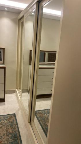 a hallway with sliding glass doors in a room with rugs at H&d abrrtment hotel 5 in Cairo